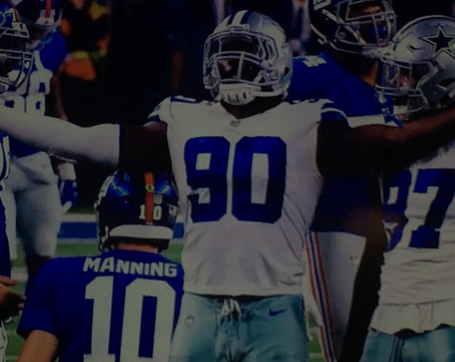 Cowboys defensive end DeMarcus Lawrence celebrating after getting a sack on Giants quarterback Eli Manning
